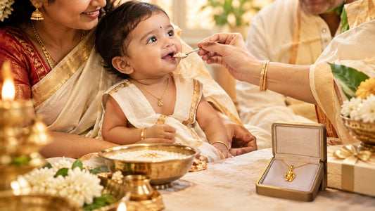 Baby fed the first spoon of rice at an annaprashan ceremony, with a LadyBug Jewels gold pendant gift in a box
