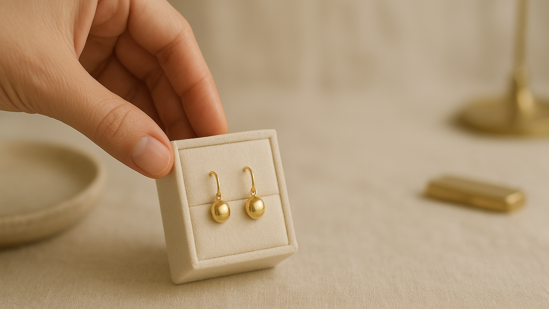 Gold earrings and bangles laid out for a newborn baby